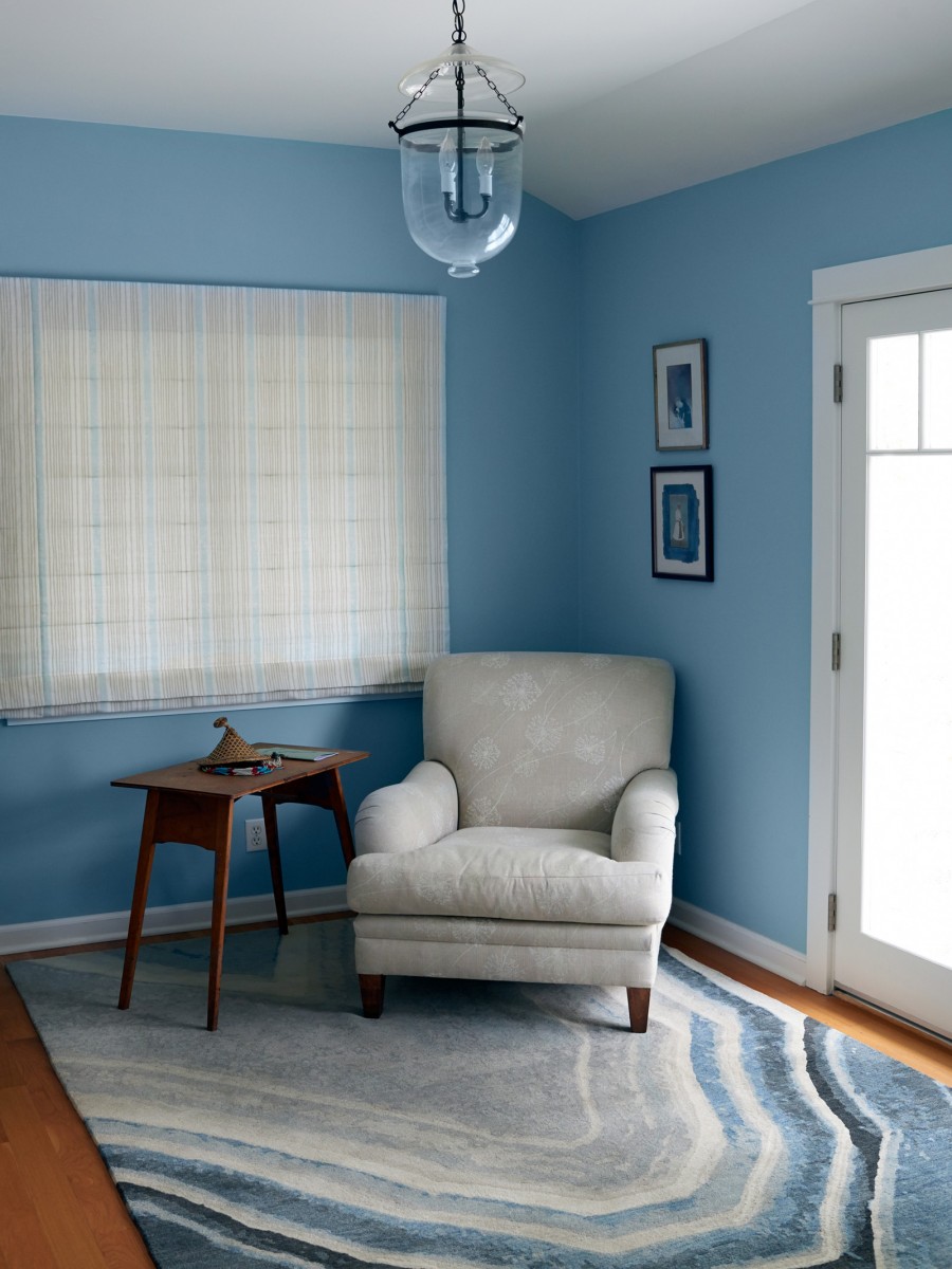 Agua Nueva Rug by Erik Lindstrom displayed in bedroom with a white chair 